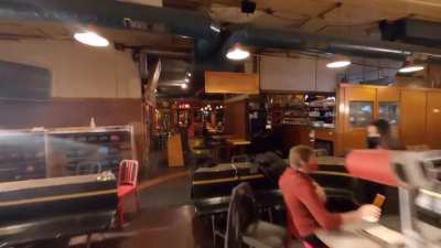 It reportedly took 12 attempts to nail this drone in a bowling alley shot. The payoff is worth the effort