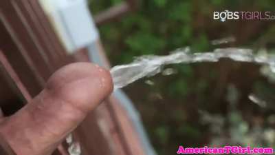 Peeing off a balcony and on her feet