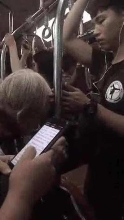 The kid on the right, places his hand between the rail and Grandma's head so, doesn’t bump to the railing.
