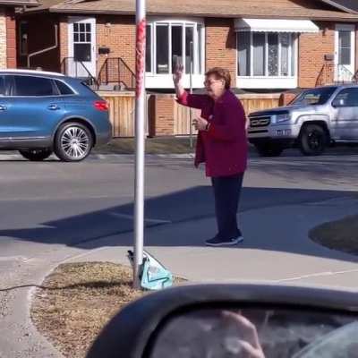 This lady stands at a 4-way stop everyday at rush hour giving virtual hugs and blowing kisses to people going by