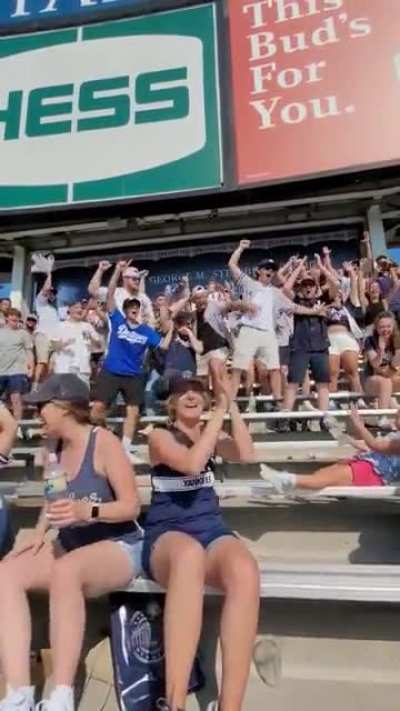 Yankees fans cheer a little girl landing a bottle flip