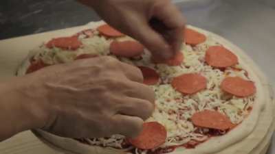 Pepperoni Pizza being made by local pizza place