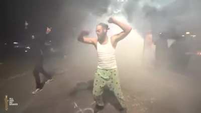 He's just vibing to the beat of the riot