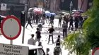 Video showing man was hit by brick thrown from pro-Beijing side. Look at the woman in the skirt.