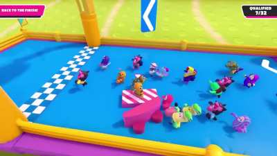 Peasants carry their king across the finish line in a chariot