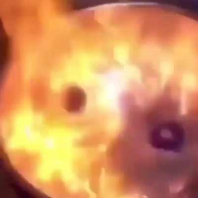 Beyblades in fire looking like the endgame in hell.