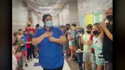 Students line the hall to cheer lunch lady who became an American citizen