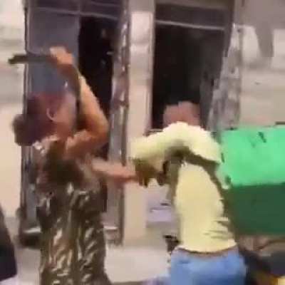 Someone sent this lady a dildo... Here she is, beating up the delivery guy.