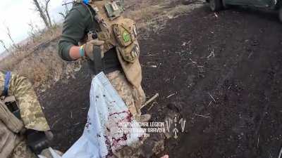 Soldiers from Bravo 2 of the International Legion performing CASEVACs on fellow wounded soldiers