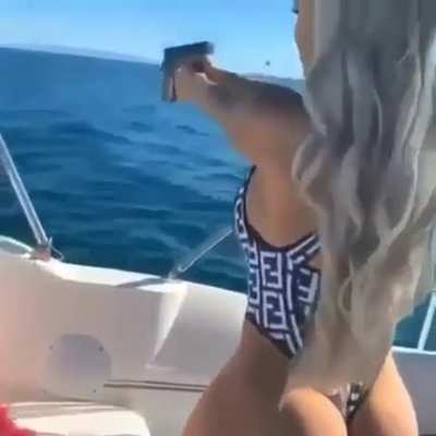 Boat, bikini, gun & butt.