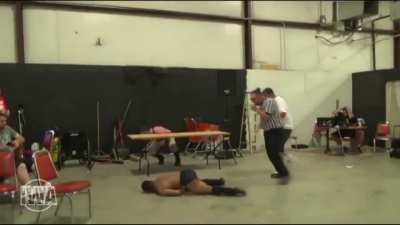 Wrestler goes for elbow drop from halfway up a wall and misses his opponent and crashes to the floor.