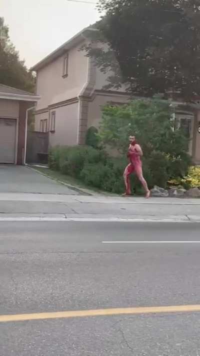 Naked man being hunted by guy with sword in broad daylight 