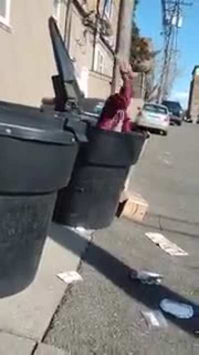 Man chilling in trash can, doesn't want to get out
