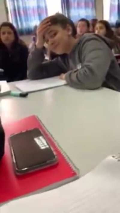 Kid receives permission from the teacher to eat a fruit during class.