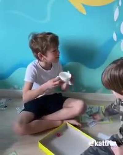 Little girl just wants to serve tea to her brother and his friends.