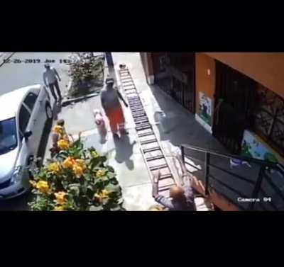 Man in wheelchair shakes a painters stepping stool since it was impeding the asphalt