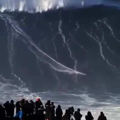 guy surfs a 100 plus ft high wave