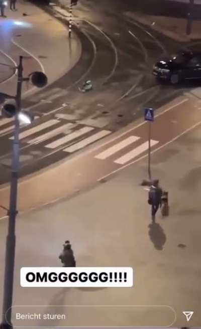 Hostage escapes from hostage-taker in Amsterdam Apple Store. Hostage-taker chases him. Police then run hostage-taker over with car.